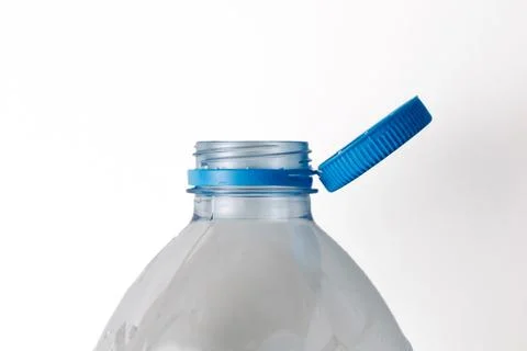 Open plastic bottle with blue cap on white background Stock Photos