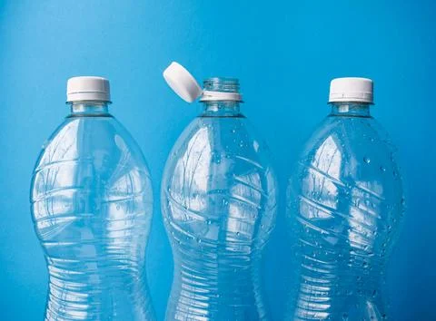Open Plastic Bottle with Cap on Blue Background, Packaging and Recycling Detail Stock Photos