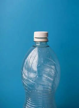 Open Plastic Bottle with Cap on Blue Background, Packaging and Recycling Detail Stock Photos