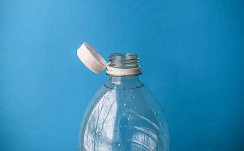 Open Plastic Bottle with Cap on Blue Background, Packaging and Recycling Detail Stock Photos