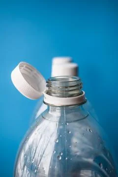 Open Plastic Bottle with Cap on Blue Background, Packaging and Recycling Detail Stock-Fotos