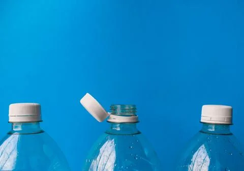 Open Plastic Bottle with Cap on Blue Background, Packaging and Recycling Detail Stock Photos