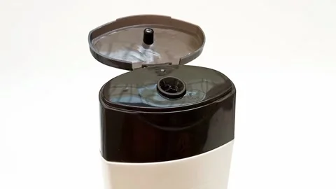 An open plastic bottle cap rotating on a white background, black color open cap Stock Footage 306445648