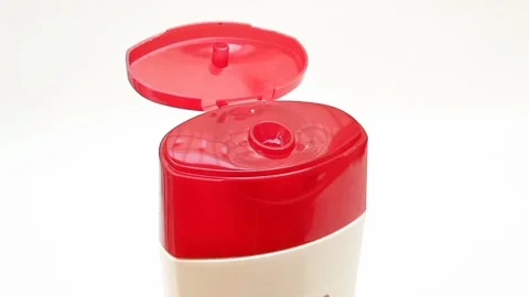 An open plastic bottle cap rotating on a white background, red color open cap Stock-Footage 306515051