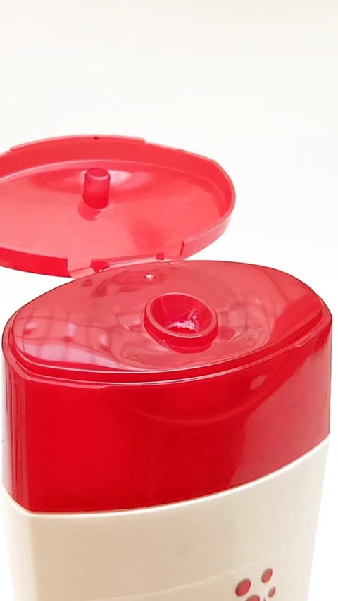 An open plastic bottle cap rotating on a white background, red color open cap Stock Footage 306570439