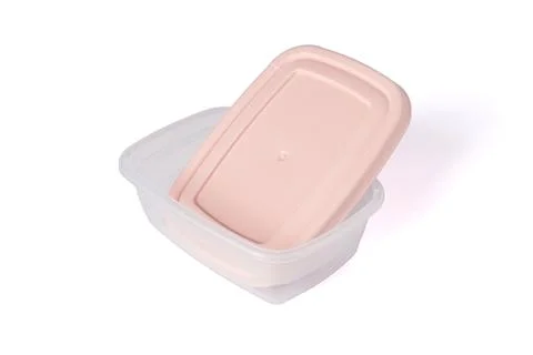 Open plastic food storage container with pink lid isolated on white background Stock Photos
