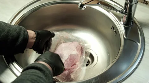Open the plastic vacuum package with a piece of pork meat to wash before cooking Stock Footage 152870948