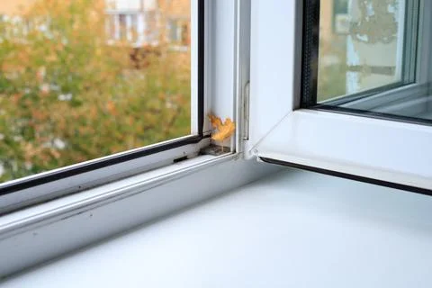 Open Plastic Window with Autumn Leaf on Frame for Home Cleaning Concept Stock Photos