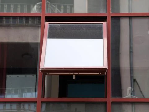 Open plastic window on the glass facade of an office building Stock Photos