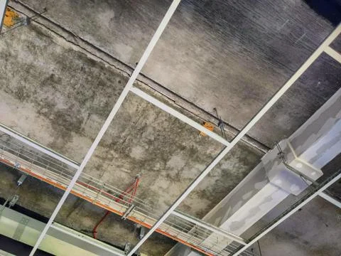 Open plenum of suspended ceiling with tiles removed from t-bar grid Stock Photos