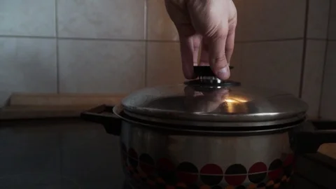 Open the pot with hot water inside 動画素材 105310262