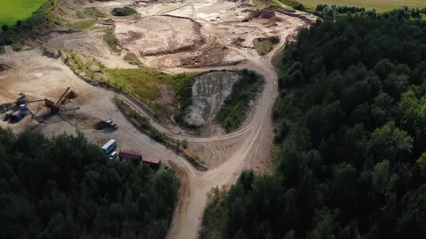 Open quarry for industrial sand mining with wheel loader and dump trucks Stock Footage 163375968
