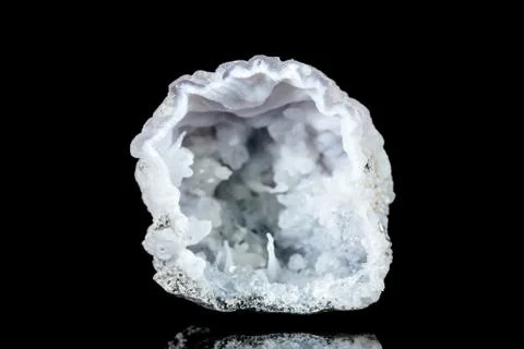 Open raw quartz druse or geode mineral stone in front of black background Stock Photos