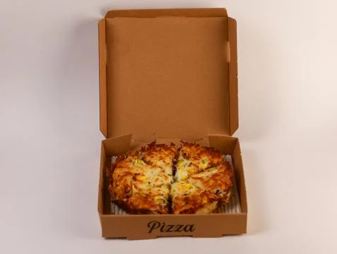 Open rectangular pizza box containing a fully sliced cheese pizza, viewed front Stock Photos