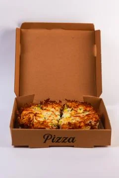 Open rectangular pizza box containing a fully sliced cheese pizza, viewed front Stock Photos