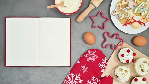Open red book appear on table with Christmas cookies and ingredients Stop motion Stock-Footage 165792531