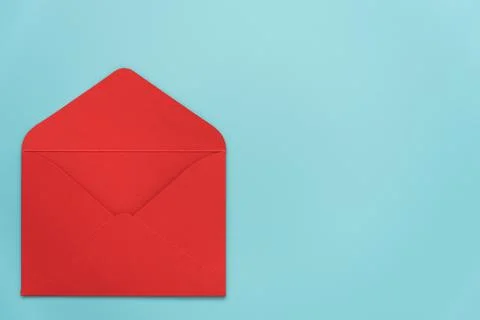 An open red envelope on a blue background. There's room for text. Stylish Stock Photos