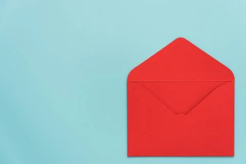An open red envelope on a blue background. There's room for text. Stylish Stock Photos