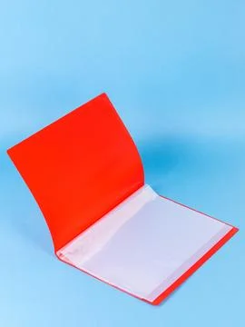 Open red plastic file folder with blank paper sheet isolated on blue, close u Foto stock