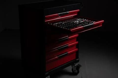 Open red tool chest with organized socket and ratchet tools in workshop Stock Photos