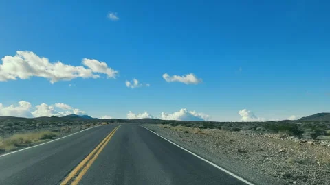 Open Road in the Desert, A deserted highway stretches into the horizon under a Video stock 272880997