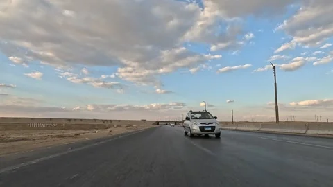Open road driving experience along Cairo Fayoum Desert Road long desert horizons Stock Footage 330081754