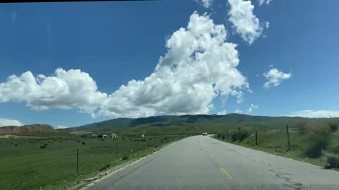 Open road driving through green countryside hills. Stock Footage 336332731