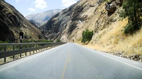 Open road through rugged mountain pass Stock Photos