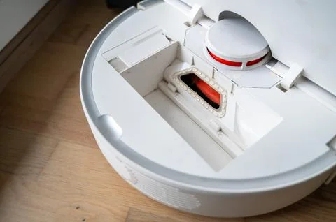 Open robot vacuum without dustbin during cleaning Stock Photos