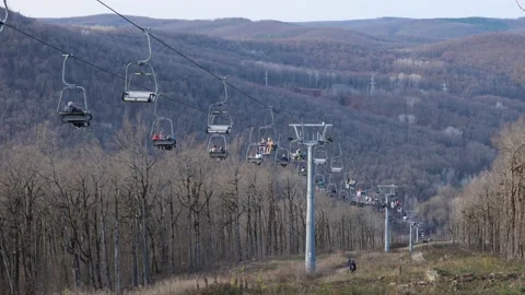 An open ropeway with people moving in ba... | Stock Video | Pond5