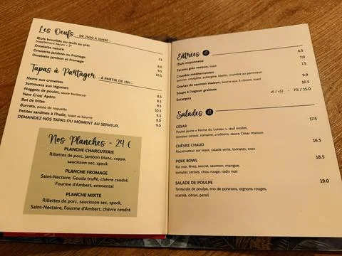 Open The Saint Placide restaurant menu photographed on a wooden table showi.. Stock-Fotos