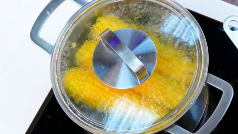 Open the saucepan with corn in boiling water Stock Footage 84301274