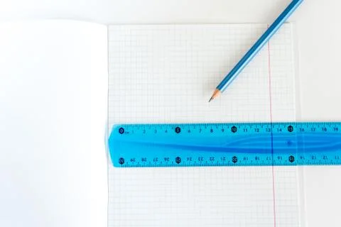 Open school notebook with a simple pencil and a ruler on a white table. back to Stock Photos