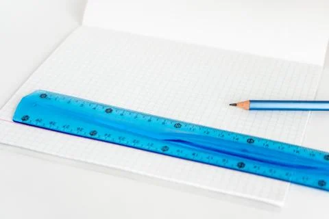 Open school notebook with a simple pencil and a ruler on a white table. back to Stock Photos