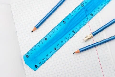 Open school notebook with a simple pencil and a ruler on a white table. back to Stock Photos