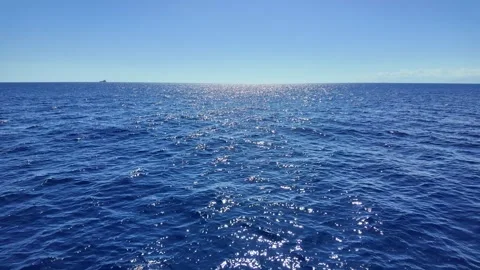 Open sea with sunlight sparkling on blue waves Stock Footage 345268204