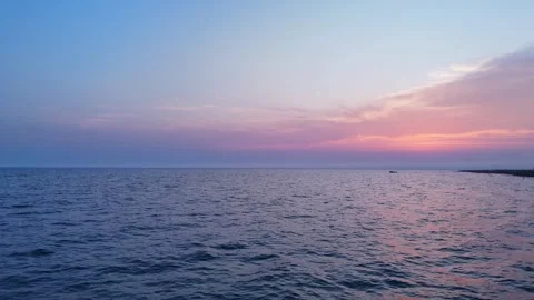 Open Sea at Sunset With Gentle Waves and Pink Blue Sky Stock Footage 314727921