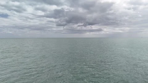 Open Sea Under Cloudy Sky with Calm Water Surface 4K Stock Footage 337846682