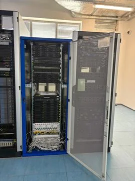 Open server rack filled with multiple networking and data storage equipment in a Foto stock