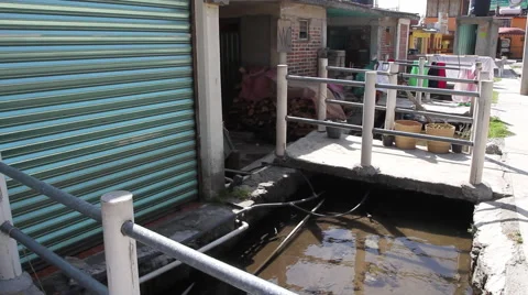 Open sewage system channel in a poor village town Video stock 67728837