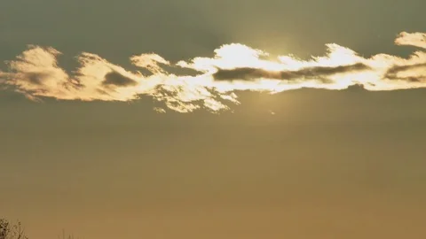 Open shot tilt from sunset behind clouds to woods Stock Footage 71210003