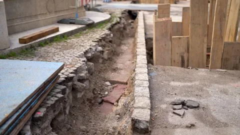Open sidewalk construction site in a city with stones Stock Footage 263645657