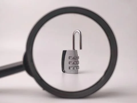 An open silver combination padlock with number dials is framed and scrutini.. Stock Photos