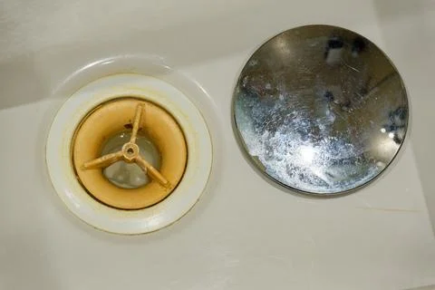 Open sink drain with removed chrome cap and exposed old trap Stock Photos