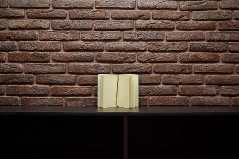 Open sketchbook is on the table. background brick wall Stock Photos