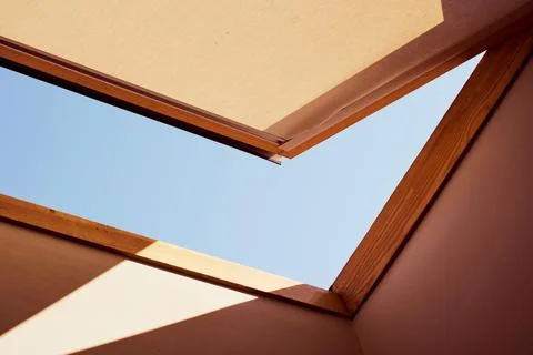 Open skylight with a piece of blue sky Stock Photos