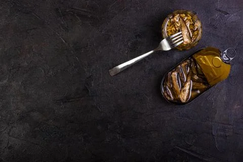 Open slots in jars and fork against a dark background Stock Photos