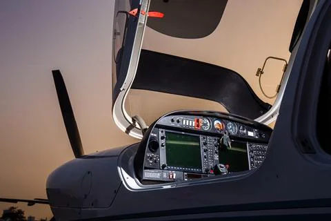 Open small private jet in sunset control panel Stock Photos