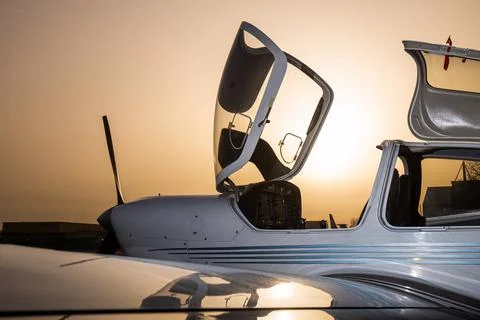 Open small private jet in sunset Stock Photos