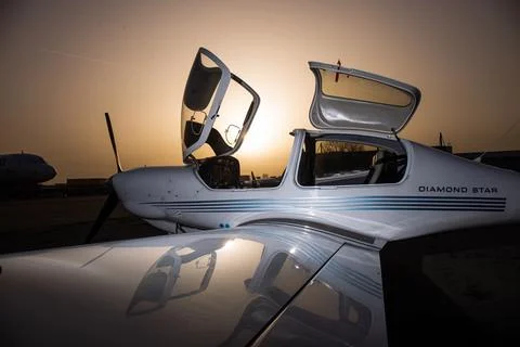 Open small private jet in sunset Stock Photos